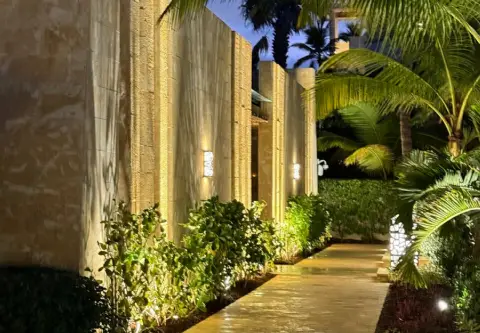 Lit entrance walkway at night